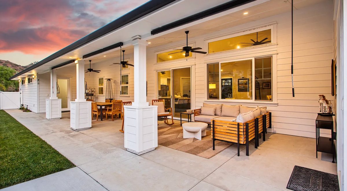 Covered porch with outdoor living space at sunset - Bay Area new construction